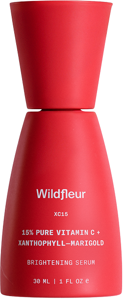 Red serum bottle with 'Wildfleur' branding on a white background