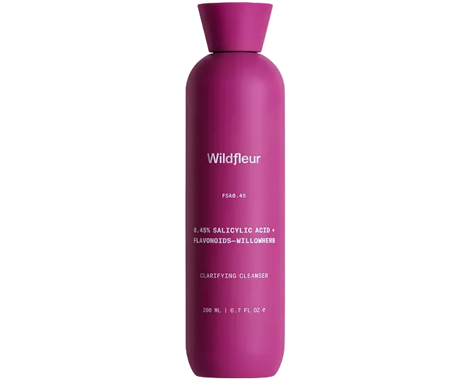 Pink bottle of Wildfleur clarifying cleanser on a white background