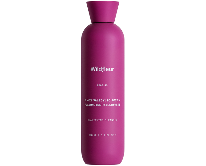 Pink bottle of Wildfleur clarifying cleanser on a white background